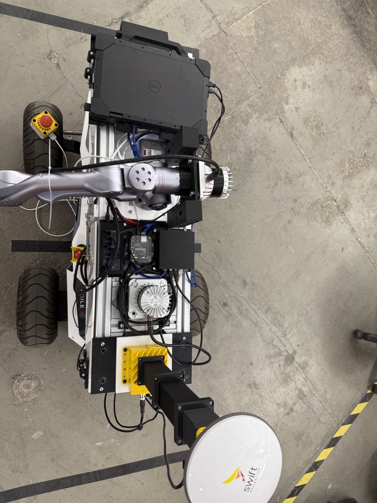 ALFRED from above, showing the arm, LiDAR, laptop and GNSS antenna laid out on the base deck